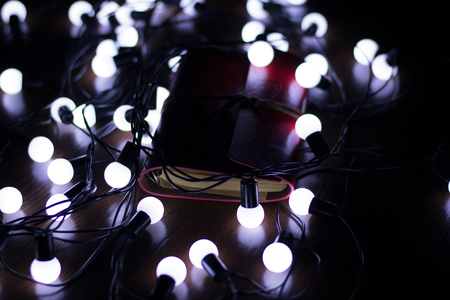 Little white lights on a garland lying on the floor, blur, creative backgroundの写真素材