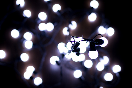 Little white lights on a garland, blur, creative background
