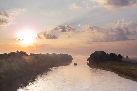 Raft floating on the river at dawn in morningの写真素材