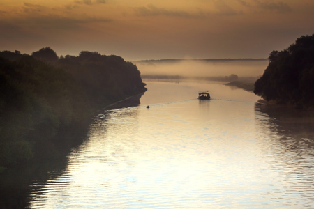 Raft floating on the river at dawn in morning