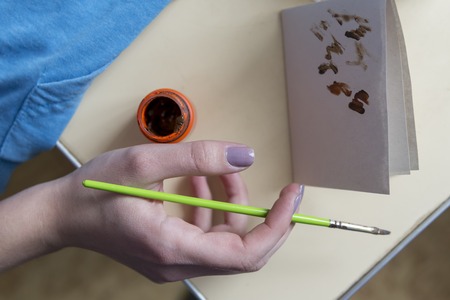 Photo of the hand with a brush, the process of drawing with colorsの写真素材