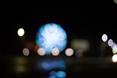 Ferris wheel and lights of the night city, blurred bright backgroundの写真素材