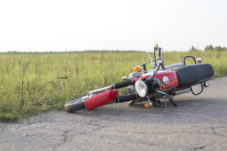 Photo red motorcycle on road, the concept of road accidentsの写真素材