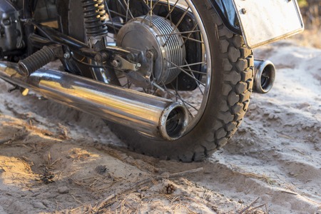 Motorcycle wheel on a sandy forest road, close-upの写真素材