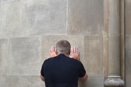 The guy with reverence touches the sacred old wallの写真素材