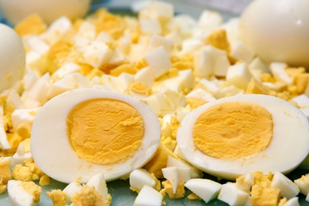 Boiled domestic egg cut in half and also sliced eggs