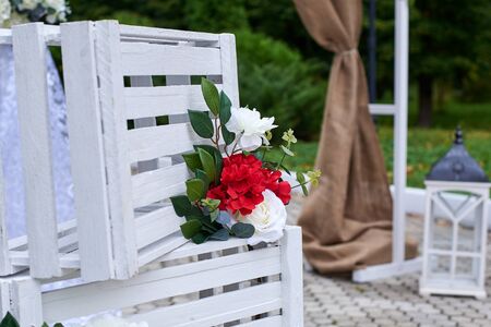 Beautiful outdoor wedding decorations, arch decorated with red and white flowers, lanterns.の写真素材