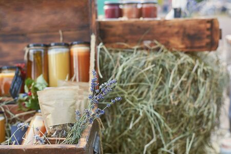 Handmade herbal tea and honey sale in a wooden box, concept of healthy eating.の写真素材