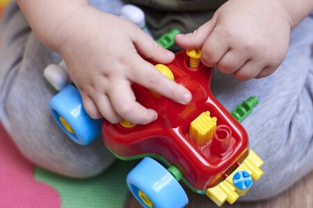 The boy plays with a car that can be disassembled, educational toys for children.の写真素材