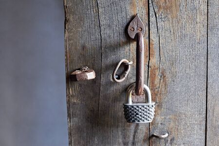 Vintage door handle and lock, fragmen of old wooden door.の写真素材