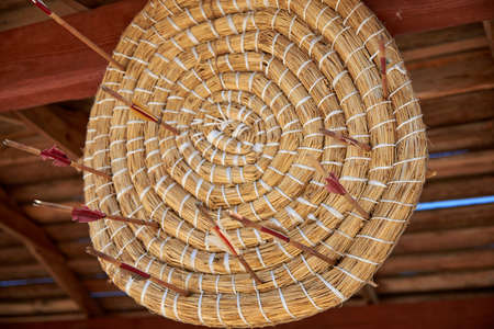 Multiple bow arrows missed the center of the straw target, failure.の写真素材