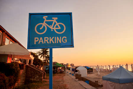 Blue bike parking sign on the sea beach.の写真素材