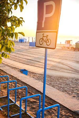 Blue bike parking sign on the sea beach.の写真素材