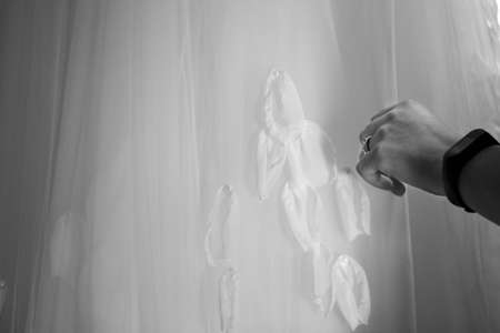 The bride touches her dress with her hand, preparing for the wedding.の写真素材