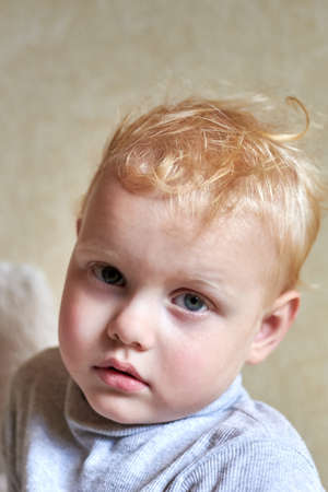 Portrait of a sleepy three year old boy, a child after sleep.