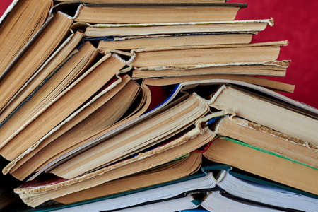 Old books piled up in a heap, close-up, learning and education concept.