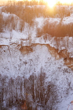 Chalk quarry and trees covered with snow, winter landscape.