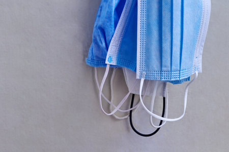 Several medical masks are hanging on the door, the concept of viral diseases, coronavirus.の写真素材