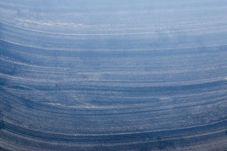 Smeared flour on a blue background looks like snow, creative background.の写真素材