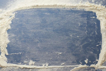 Smeared flour in frame on a blue background, creative background.の写真素材