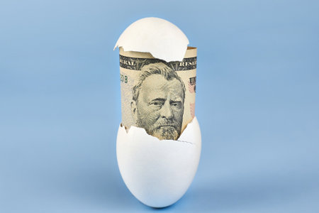 American fifty dollar bill from eggshell on blue background, earnings concept.の写真素材