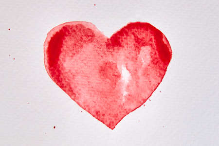 Drawing of a red heart shape in watercolor on white paper, Valentine's Day theme.の写真素材