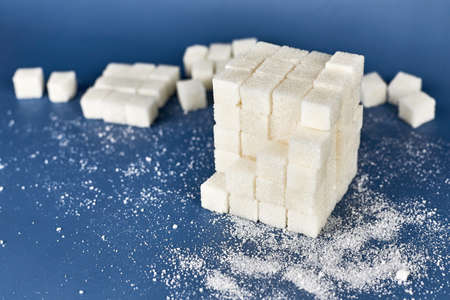 Heap of white sugar cubes on a blue background.の写真素材