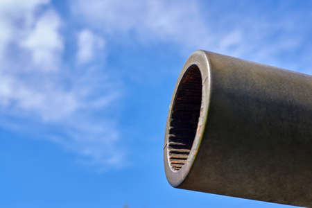 Tank cannon on a background of blue sky, close-up, the concept of war.の写真素材