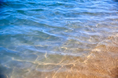 Transparent calm sea surface on a sunny day, summer background.の写真素材