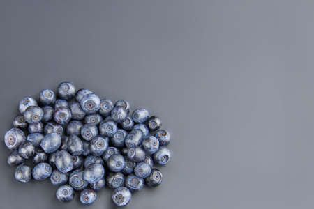 Heap of fresh ripe blueberries on a gray background, copy space.の写真素材