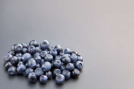 Heap of fresh ripe blueberries on a gray background, copy space.の写真素材