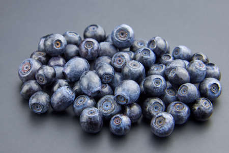 Heap of fresh ripe blueberries on a gray background, copy space.の写真素材