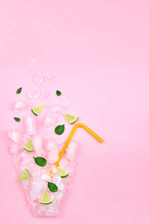 Flat lay composition, ice, mint, lime in the form of a glass on a pink background, copy space.の写真素材