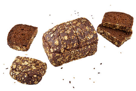 Dark rye bread with whole sunflower seeds, flaxseeds and oatmeal on top isolated on white background.の写真素材