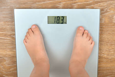 The feet of a three-year-old boy on the scales.の写真素材