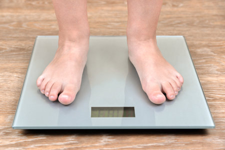 The feet of a three-year-old boy on the scales.の写真素材