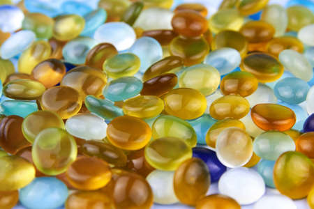 Multi-colored glass stones polished by the sea, backdrop.の写真素材