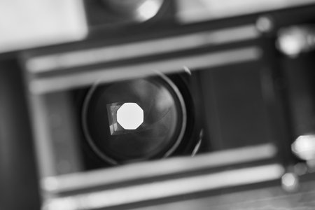 Old retro camera with open shutter and diaphragm, black and white photo.の写真素材