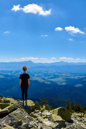A woman on top of a rocky mountain, copy space.の写真素材