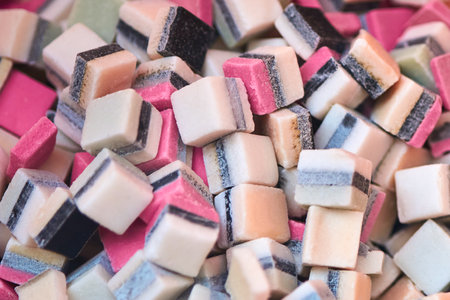 Square colored sugar candies, close-up, backdrop.