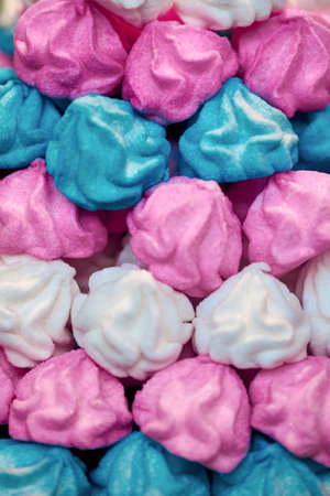 Background of baked multicolored meringue cookies, backdrop.の写真素材