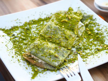 katmer dessert of Turkey Gaziantep region. Prepared with thin dough dessert with ice cream and green pistachio.の写真素材