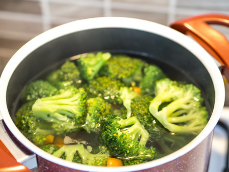 vegetables of broccoli in boiling pots. broccoli boiling on the stove in the kitchenの写真素材