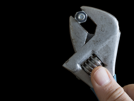 with a monkey wrench and screw nut on black backgroundの写真素材