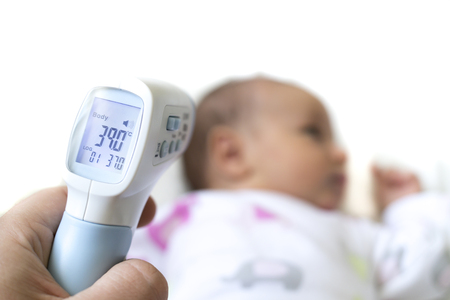 Measure baby's fever with digital fever meter. sick baby with high fever