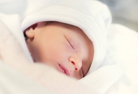 image of sleeping baby in white clothes. little baby sleeping comfortably