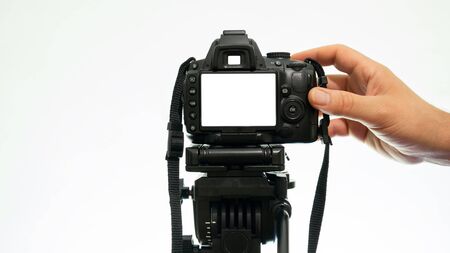Hand taking pictures with a DSLR camera. mockup camera viewの写真素材