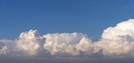 dense cloud clusters in blue skyの写真素材