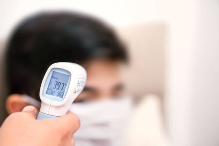 person wearing a mask and fever measurement