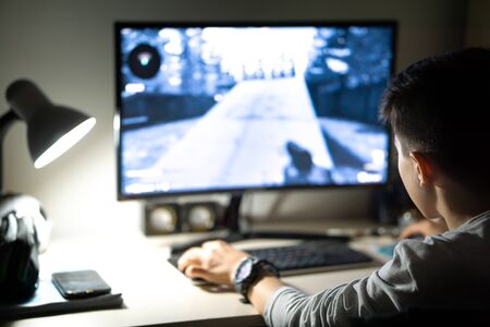 child playing games on computer in roomの写真素材